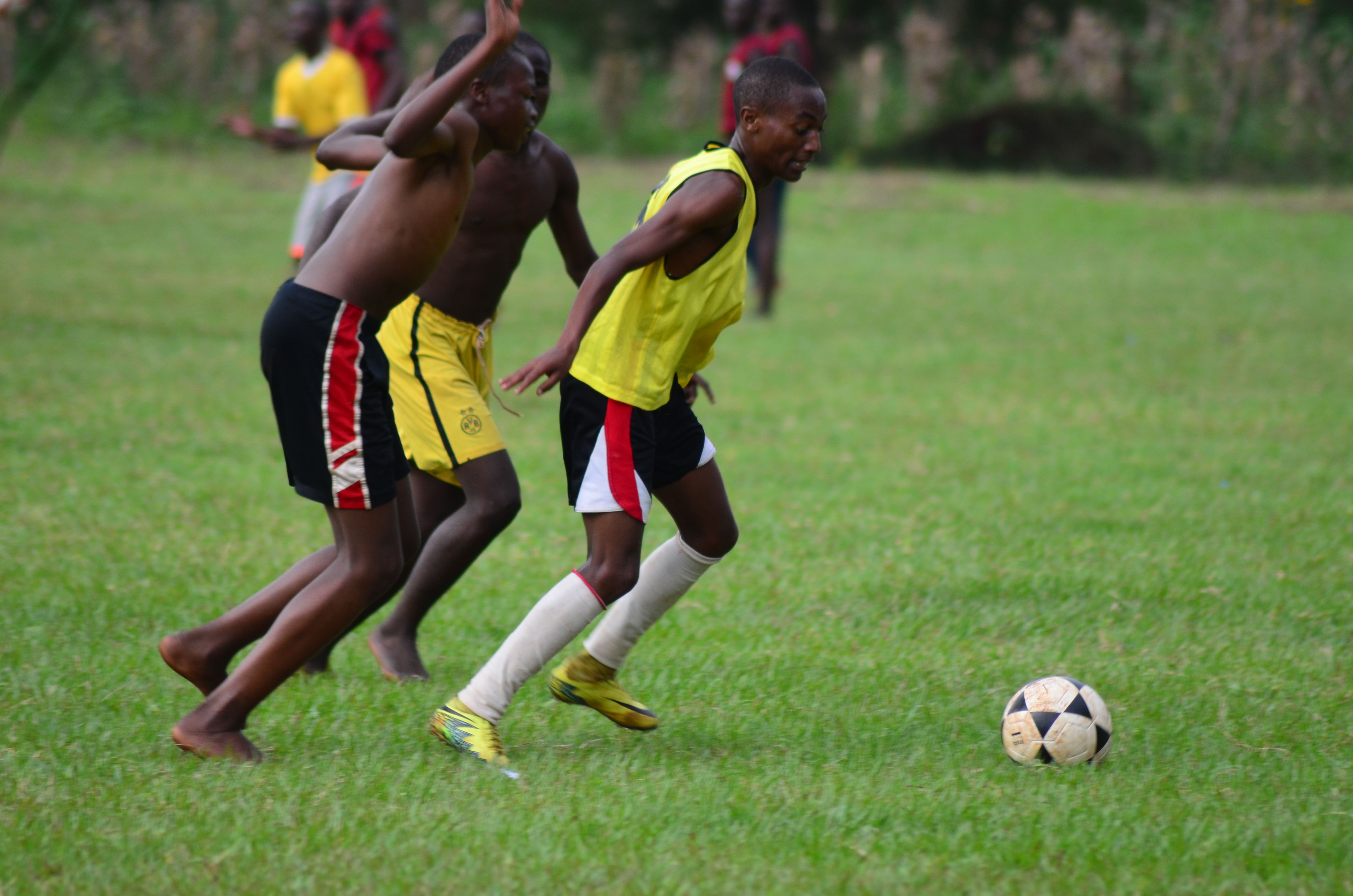 Young athletes playing soccer on a grass field